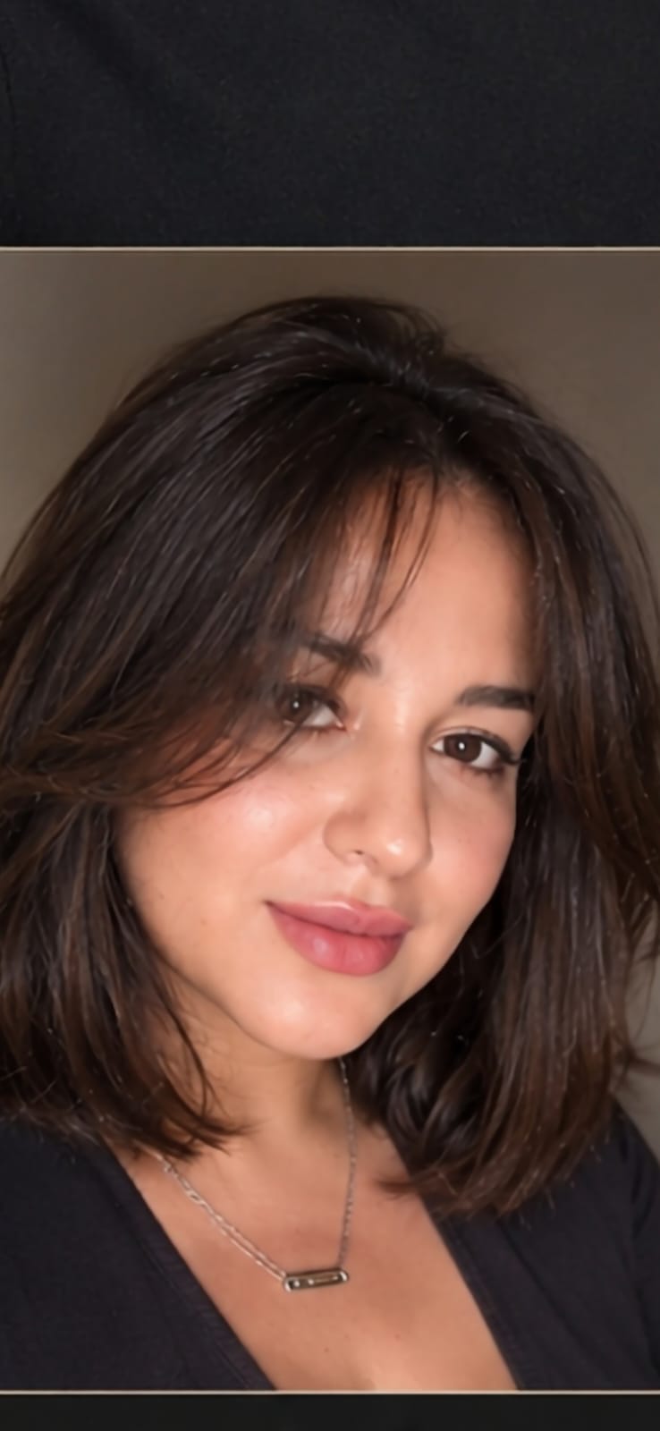 Close-up portrait of a woman with shoulder-length dark hair