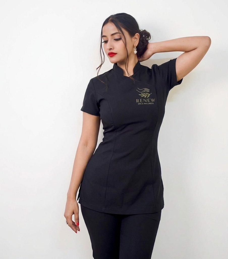 Spa professional in a black wellness uniform