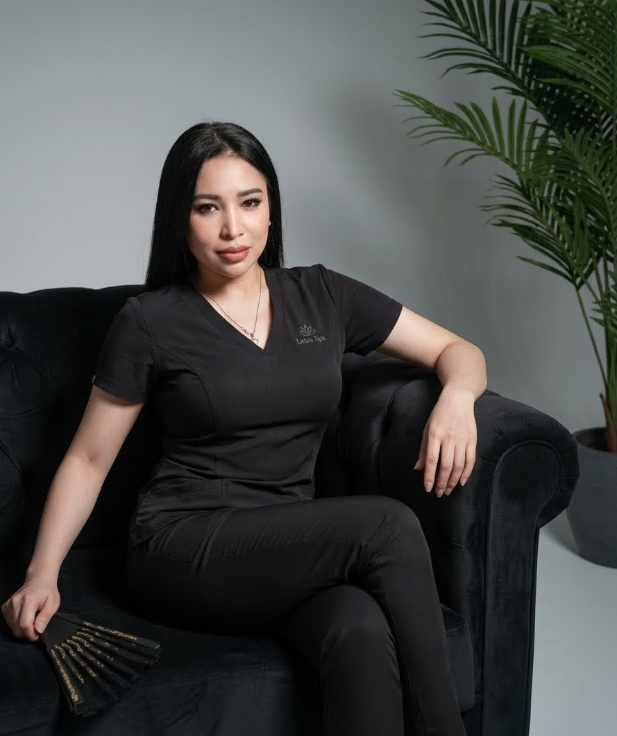Spa professional seated beside tropical greenery